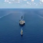 US Navy aircraft carrier George Washington sailing in formation with escort ships during a photo exercise