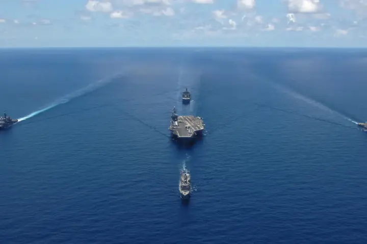 US Navy aircraft carrier George Washington sailing in formation with escort ships during a photo exercise