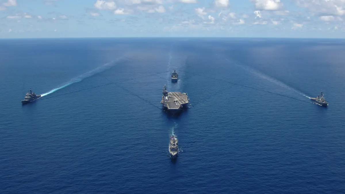 US Navy aircraft carrier George Washington sailing in formation with escort ships during a photo exercise