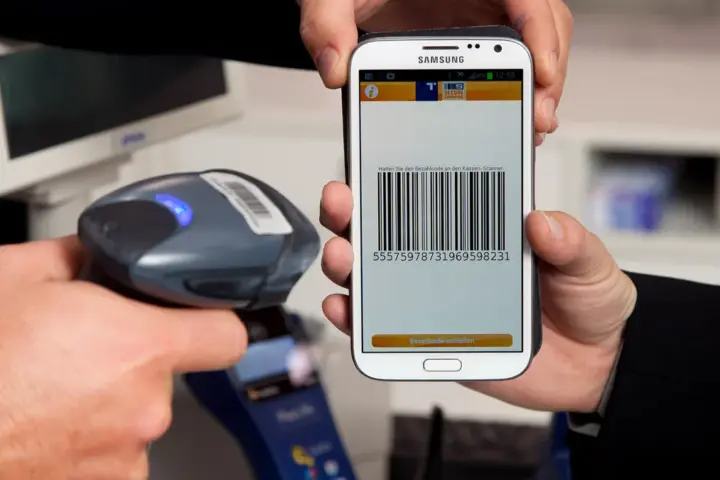 A person uses a smartphone to complete a digital payment.