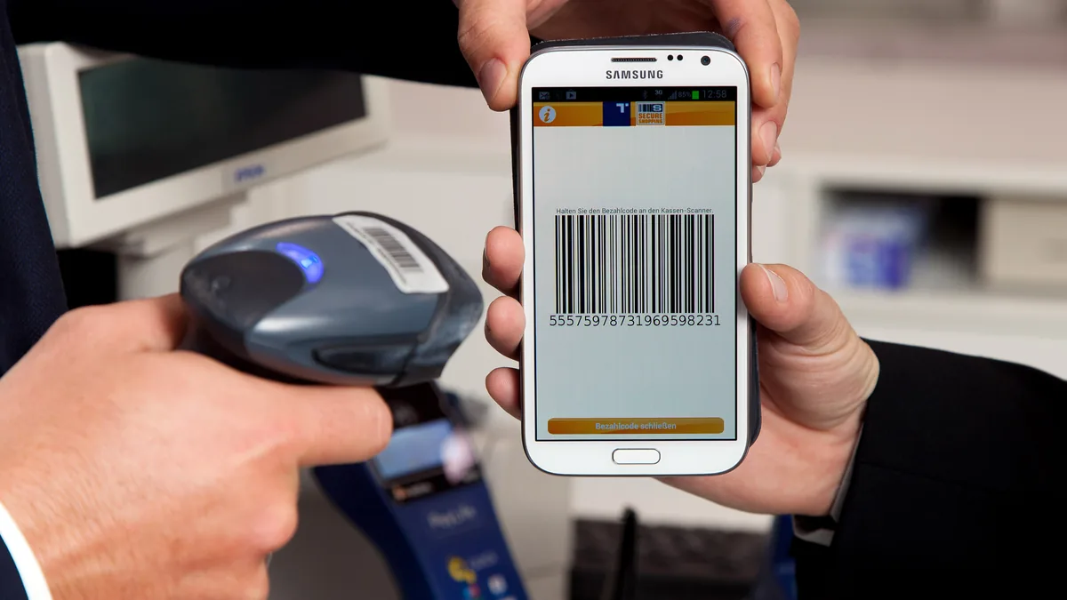 A person uses a smartphone to complete a digital payment.