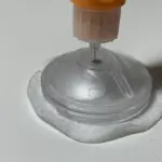 A continuous glucose monitor sensor being inserted with a medical applicator on a neutral surface