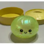 A recalled squishy toy split open to show colorful water beads inside.
