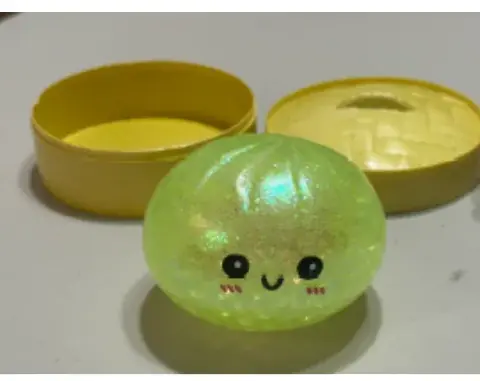 A recalled squishy toy split open to show colorful water beads inside.