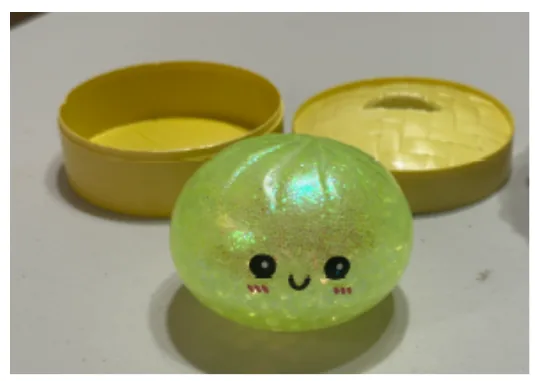 A recalled squishy toy split open to show colorful water beads inside.