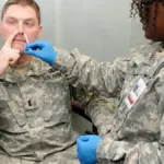 Nurse administering an influenza vaccination dose to an adult in a clinical health facility.