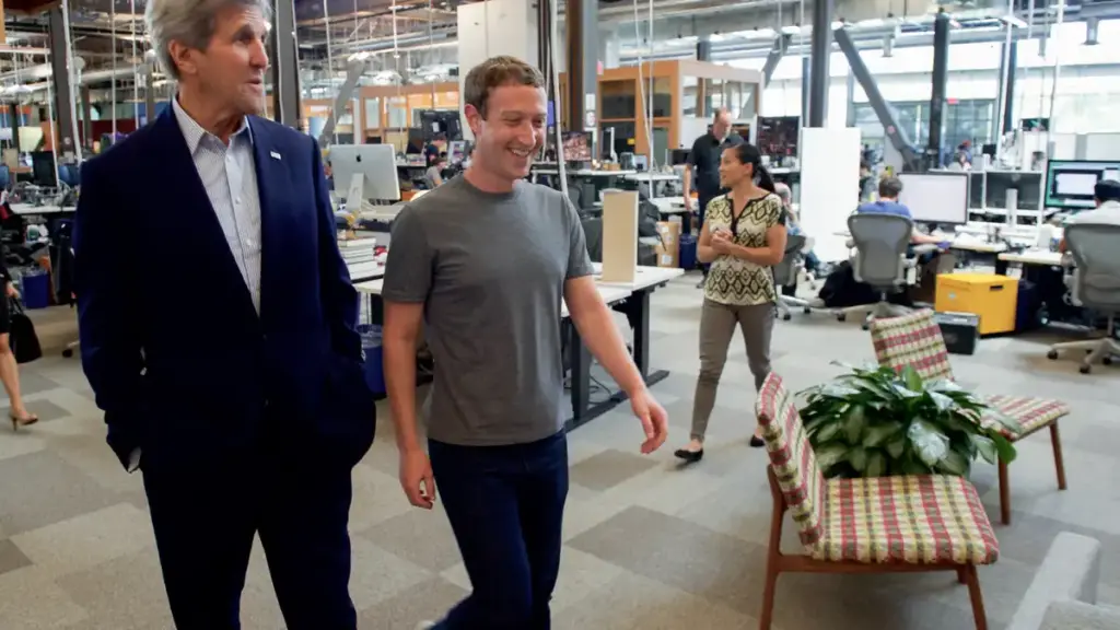 Mark Zuckerberg walking through the open-plan office space at Meta Platforms headquarters in Menlo Park.