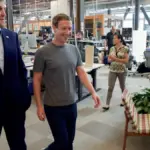 Mark Zuckerberg walking through the open-plan office space at Meta Platforms headquarters in Menlo Park.