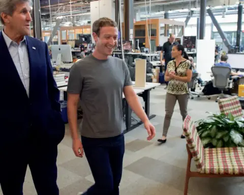 Mark Zuckerberg walking through the open-plan office space at Meta Platforms headquarters in Menlo Park.
