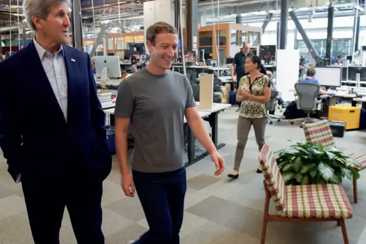 Mark Zuckerberg walking through the open-plan office space at Meta Platforms headquarters in Menlo Park.