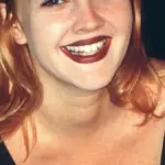 Portrait photograph of actress and television talk show host Drew Barrymore smiling at a public event.