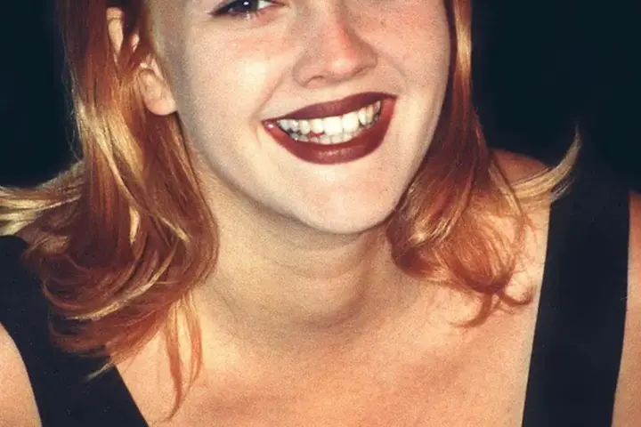 Portrait photograph of actress and television talk show host Drew Barrymore smiling at a public event.