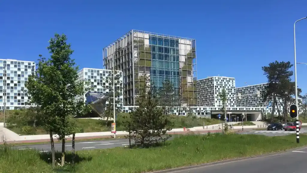 Exterior facade of the International Criminal Court building in The Hague showing modern glass panels and geometric architectural towers.