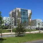 Exterior facade of the International Criminal Court building in The Hague showing modern glass panels and geometric architectural towers.
