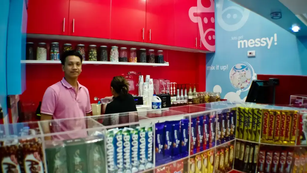 Commercial beverage prep counter showing electric blender jars and stainless-steel drink mixing stations in a cafe kitchen.