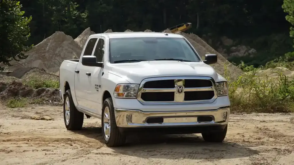 Modern Ram 1500 pickup truck parked on pavement showing front fascia, cab profile, and wheels.