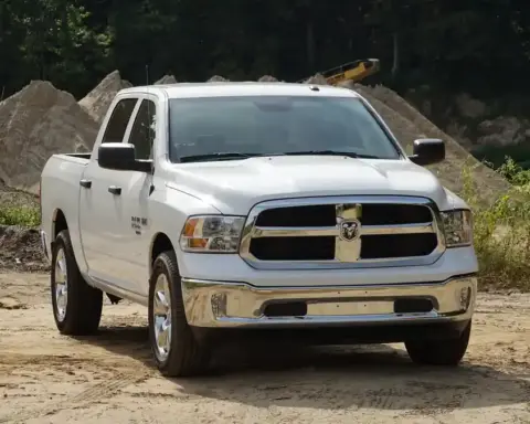 Modern Ram 1500 pickup truck parked on pavement showing front fascia, cab profile, and wheels.