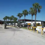 A heavy commercial truck tractor unit parked at a commercial diesel fueling station.