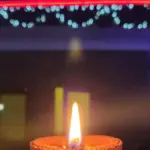 A residential home decorated with strings of LED lights and rows of traditional clay diya lamps illuminating the entrance for Diwali