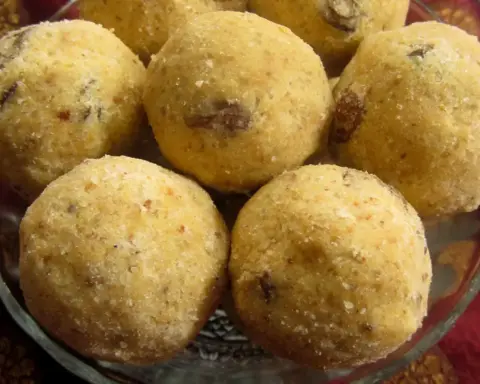 A plate of golden-brown besan ladoo sweets made from gram flour and sugar, arranged for Diwali sharing