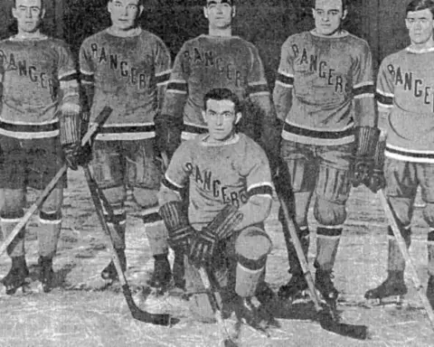 Historic black and white photograph of New York Rangers ice hockey players in team jerseys on the rink