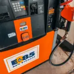 Detailed view of an E85 85 percent ethanol fuel pump nozzle and dispenser panel at an automotive service station.