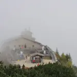 Stone building of the Kehlsteinhaus sitting on a steep alpine ridge in the Bavarian Alps.