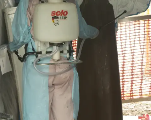 A medical isolation ward or treatment unit with healthcare workers