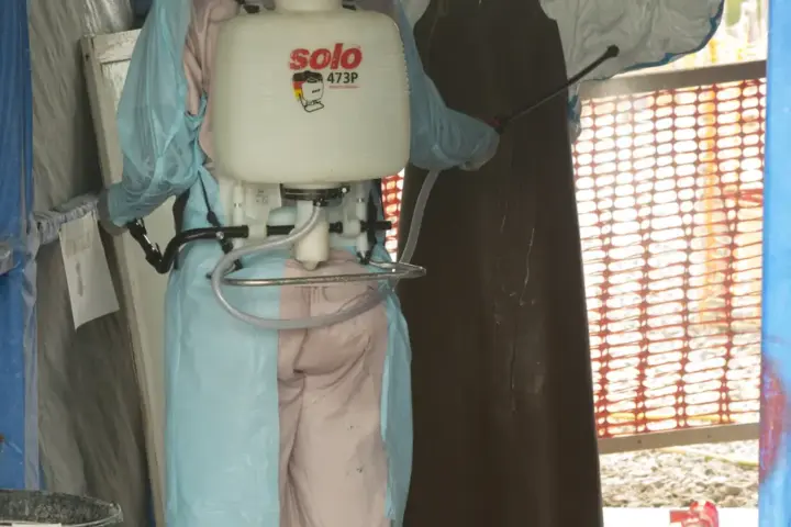 A medical isolation ward or treatment unit with healthcare workers