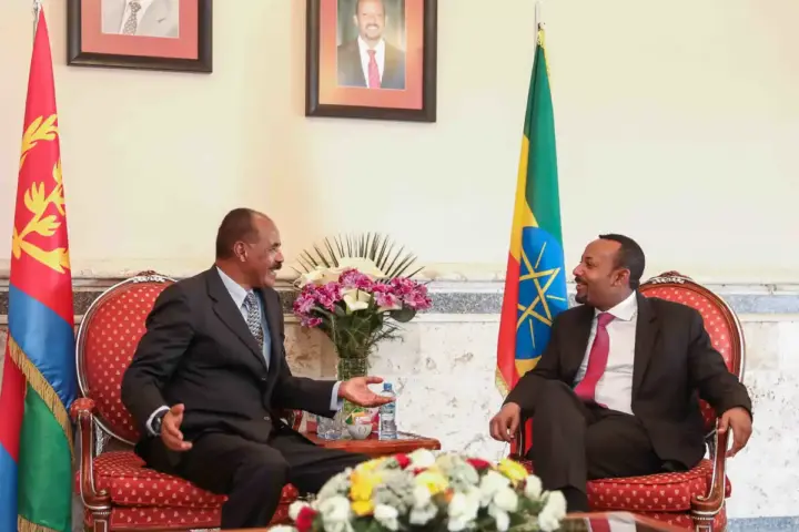 Ethiopian Prime Minister Abiy Ahmed and Eritrean President Isaias Afwerki speaking together in Eritrea in 2019, representing diplomatic relations between the two Horn of Africa nations