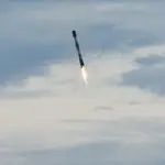 Dramatic high-resolution photograph of a SpaceX Falcon 9 first-stage orbital booster landing vertically on its landing legs amidst smoke at Cape Canaveral.