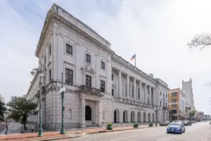 Exterior of the John Minor Wisdom U.S. Court of Appeals building in New Orleans with columns and columns reading Fifth Circuit