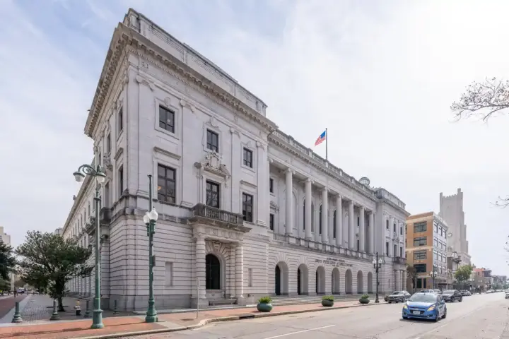 Exterior of the John Minor Wisdom U.S. Court of Appeals building in New Orleans with columns and columns reading Fifth Circuit