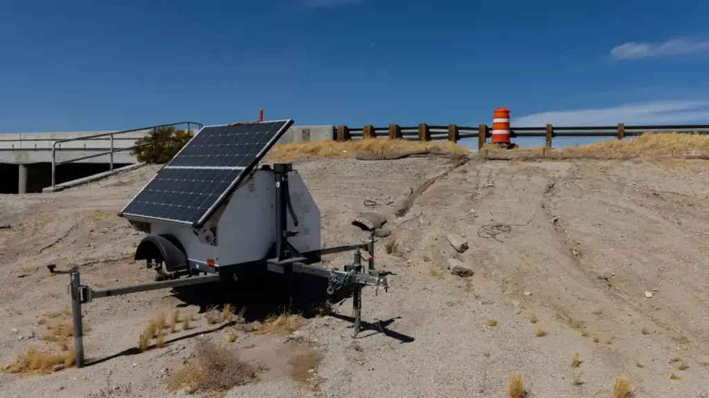 Automated license plate reader camera unit and power equipment stationed beside a roadway