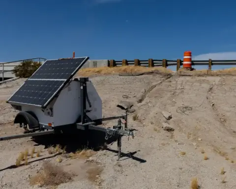 Automated license plate reader camera unit and power equipment stationed beside a roadway