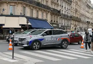 French National Police vehicles and crowd control units positioned along an urban street during a public protest.
