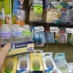 Several baby bottles on a shelf.