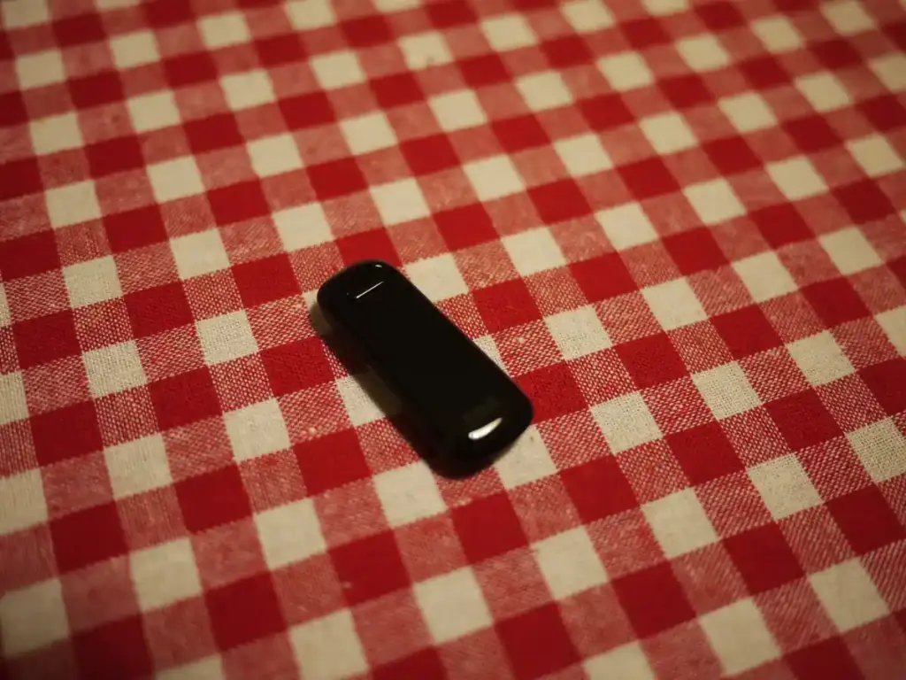 A wearable fitness tracking wristband displayed on a flat surface.