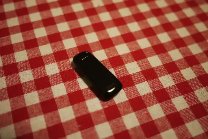 A wearable fitness tracking wristband displayed on a flat surface.