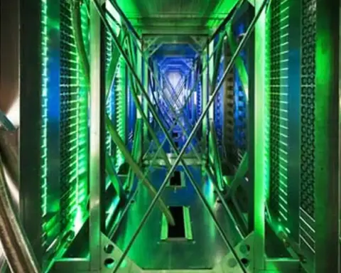 A large data center facility with server containers and cooling infrastructure visible on the building exterior