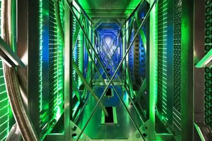A large data center facility with server containers and cooling infrastructure visible on the building exterior