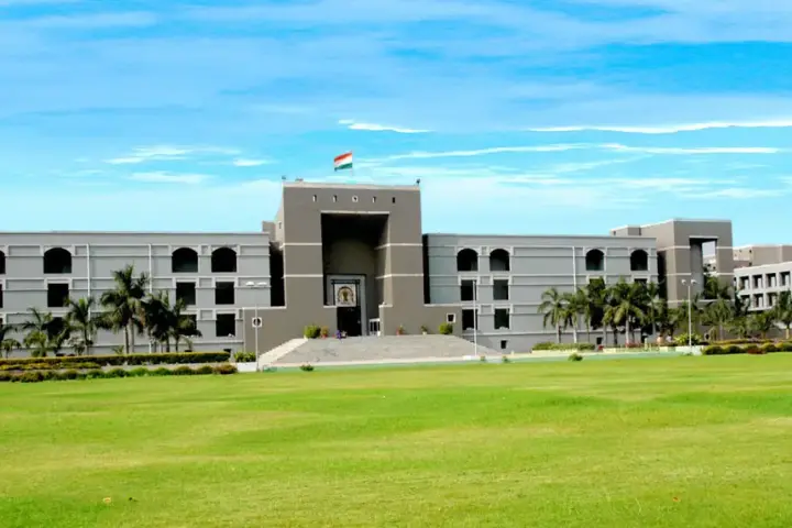 Front architectural view of the Gujarat High Court judicial complex in Ahmedabad under an open sky.