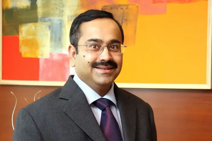 Anup Bagchi wearing spectacles and a business suit during an executive corporate portrait session representing HDFC Bank leadership transition