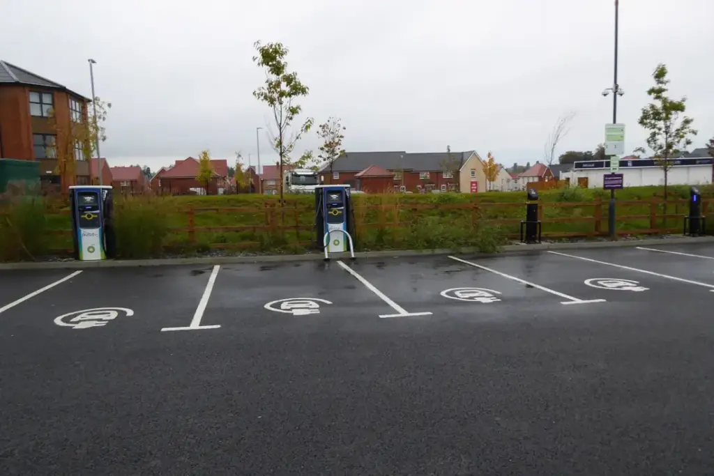 Electric vehicle charging points with BP Pulse stations and cables, illustrating infrastructure for EV adoption.