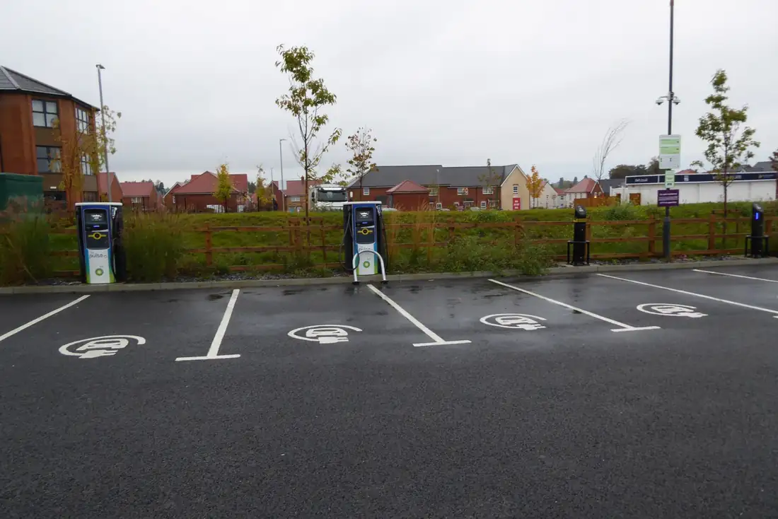 Electric vehicle charging points with BP Pulse stations and cables, illustrating infrastructure for EV adoption.