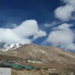 An Indian Army or paramilitary vehicle driving through a mountainous border region