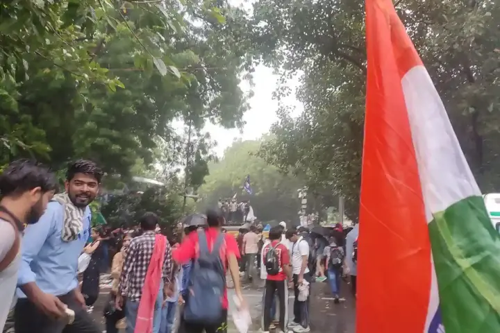 Wide photograph of young citizens and students gathering with protest placards along the designated demonstration street at Jantar Mantar, New Delhi.