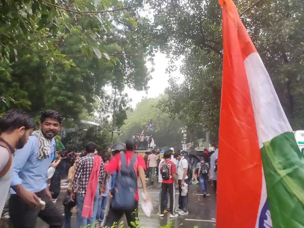 Wide photograph of young citizens and students gathering with protest placards along the designated demonstration street at Jantar Mantar, New Delhi.