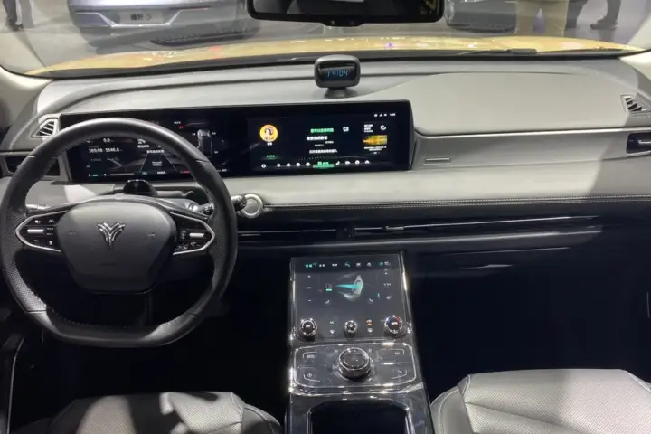 Interior of an electric sedan showing digital instrument cluster and touchscreen infotainment display