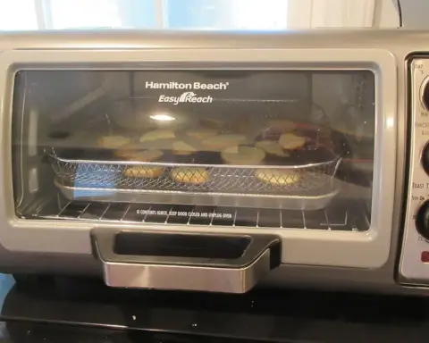 Countertop oven using an air fryer function illustrating the Kalorik MAXX safety warning